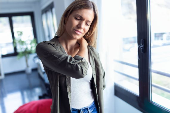 tired-young-woman-with-neck-and-back-pain-standing-2022-09-13-04-20-19-utc