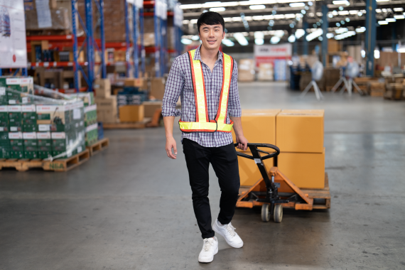 warehouse-worker-pulling-manual-hand-pallet-lift-2022-10-07-21-43-50-utc