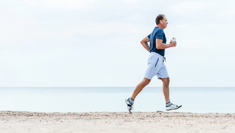 Elderly,Man,Runs,Early,Morning,By,Sea,Beach.,Active,Senior