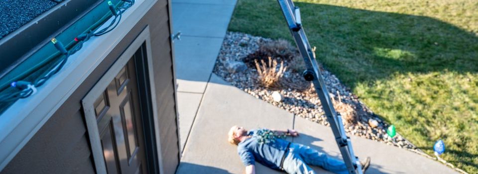 christmas lights, man fallen off ladder Shutterstock