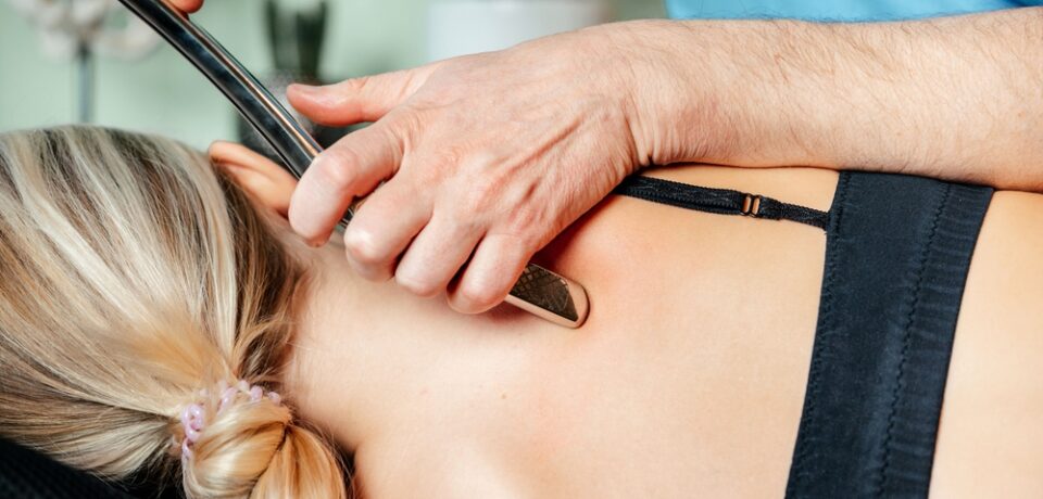 Performing,Myofascial,Release,Techniques,With,Iastm,Tool,For,The grafton on female back